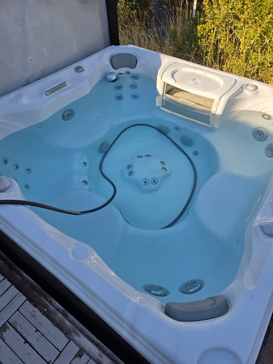 Hot tub being refilled with fresh water after drain and clean