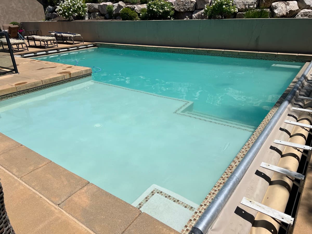 Crystal clear pool with landscaped backyard