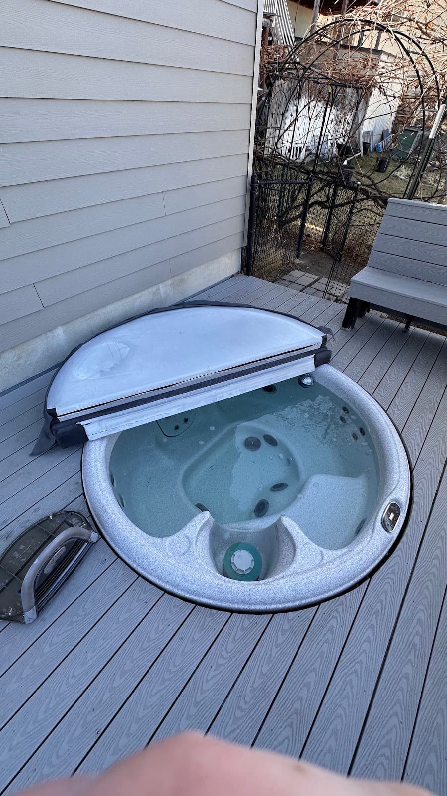 Round hot tub on wooden deck after cleaning